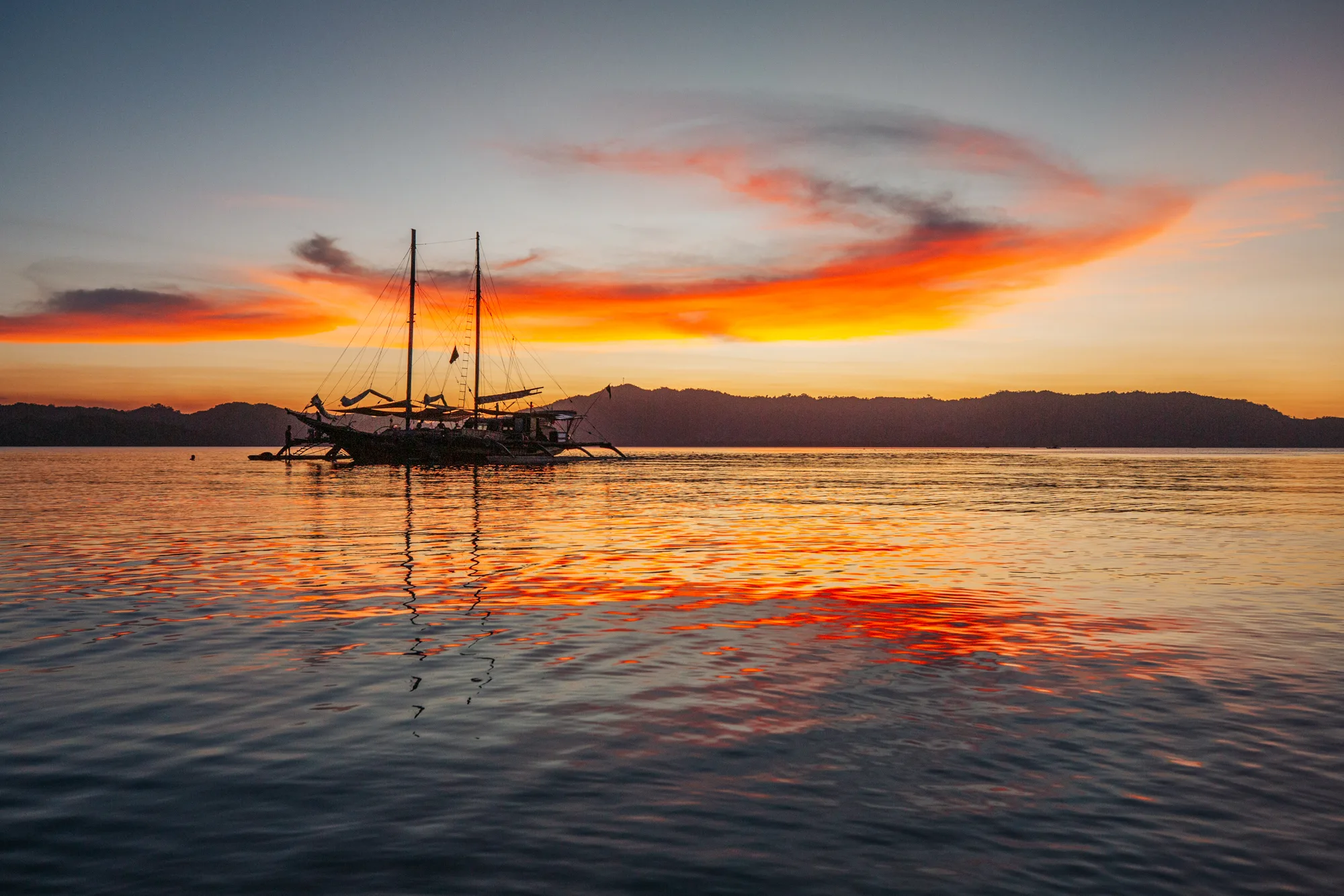 Step into the pages of a long-forgotten adventure book with a few days aboard our traditional paraw, a unique Filipino sailboat. The largest active paraw in the Philippines, Balatik is a spacious outrigger sailboat adorned with intricate indigenous carvings.